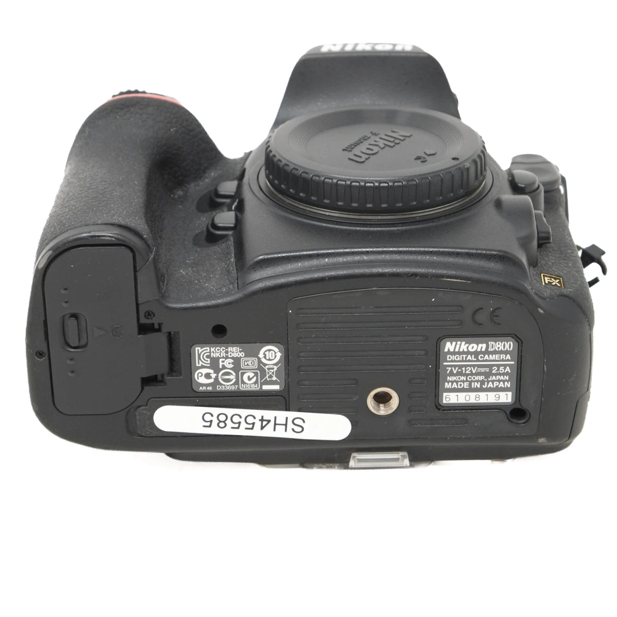 Nikon D8100 DSLR camera body shown from the back, featuring the black textured grip, lens mount, and various model specifications and labels.