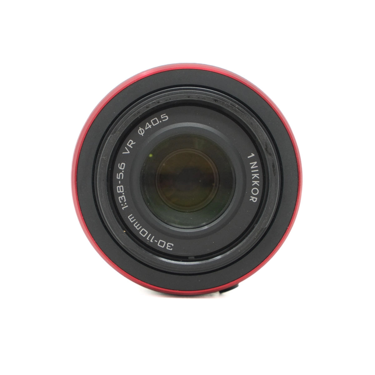 Camera lens with red rim and 'Nikkor' branding on a white background