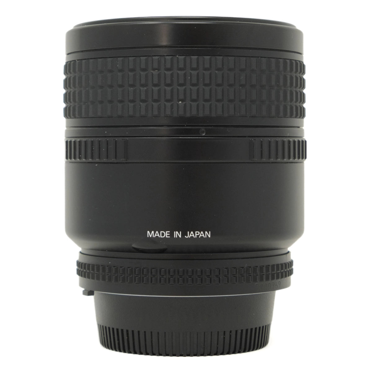 Black camera lens with 'MADE IN JAPAN' text on a white background