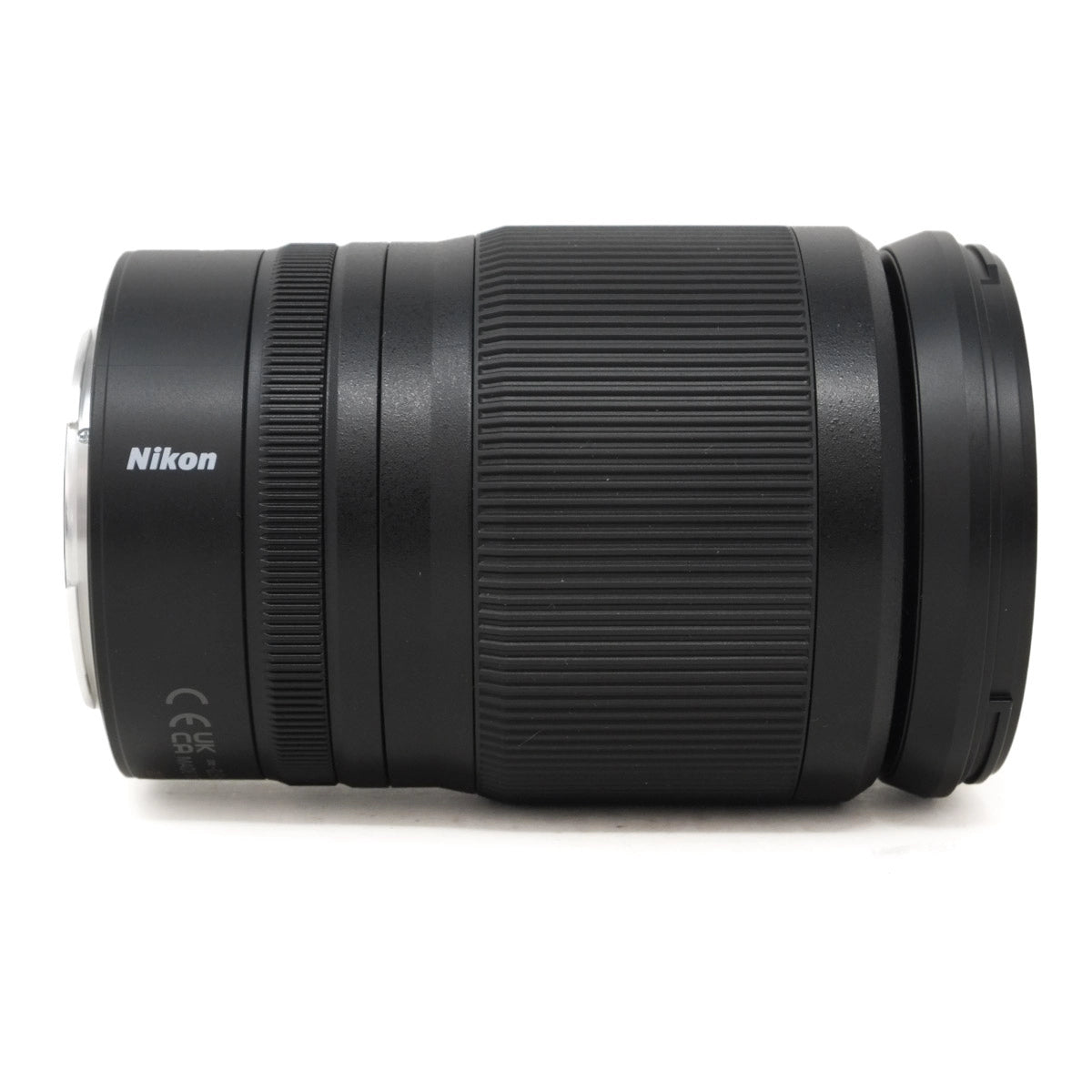 Black Nikon camera lens on a white background