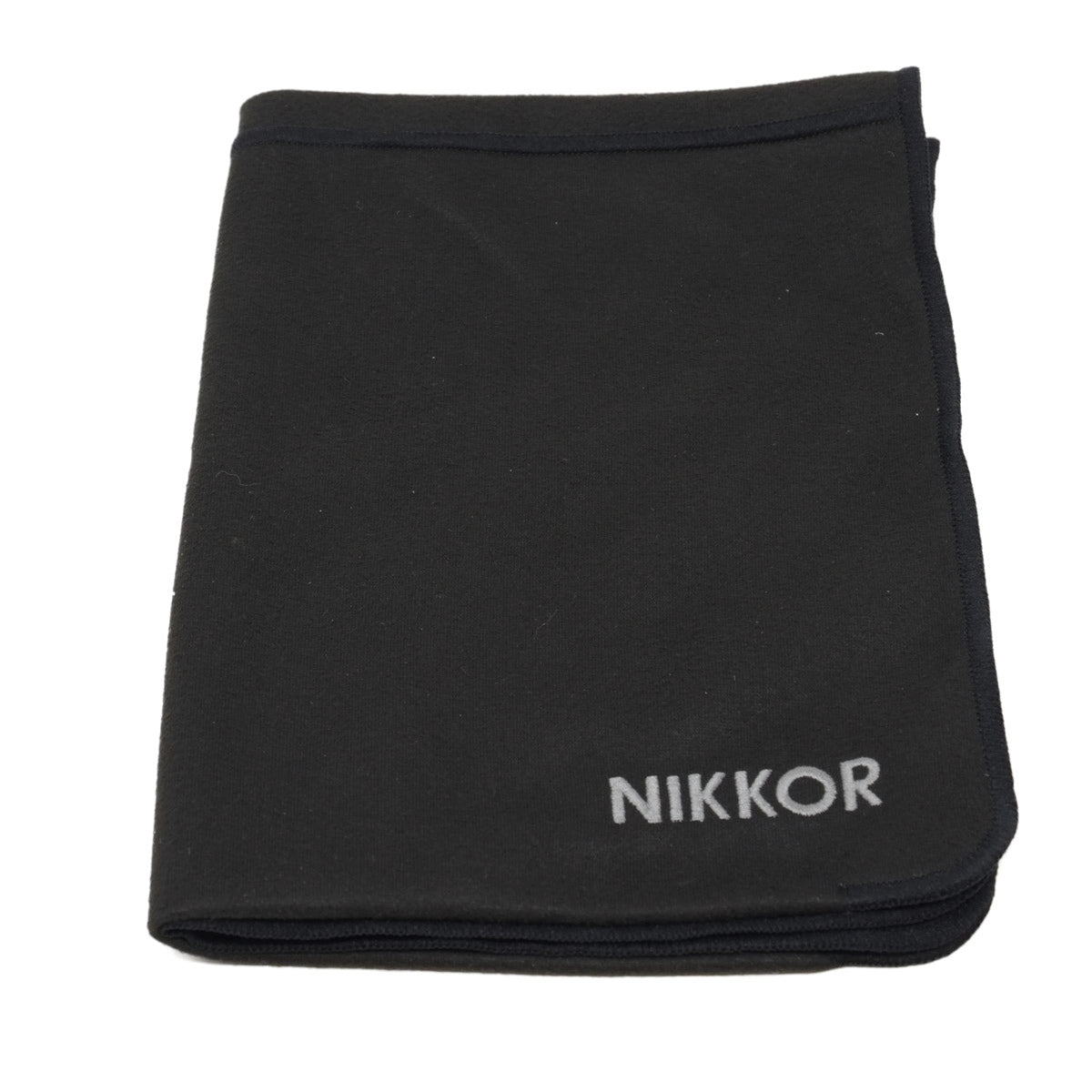 Black cloth with 'Nikkor' branding on a white background