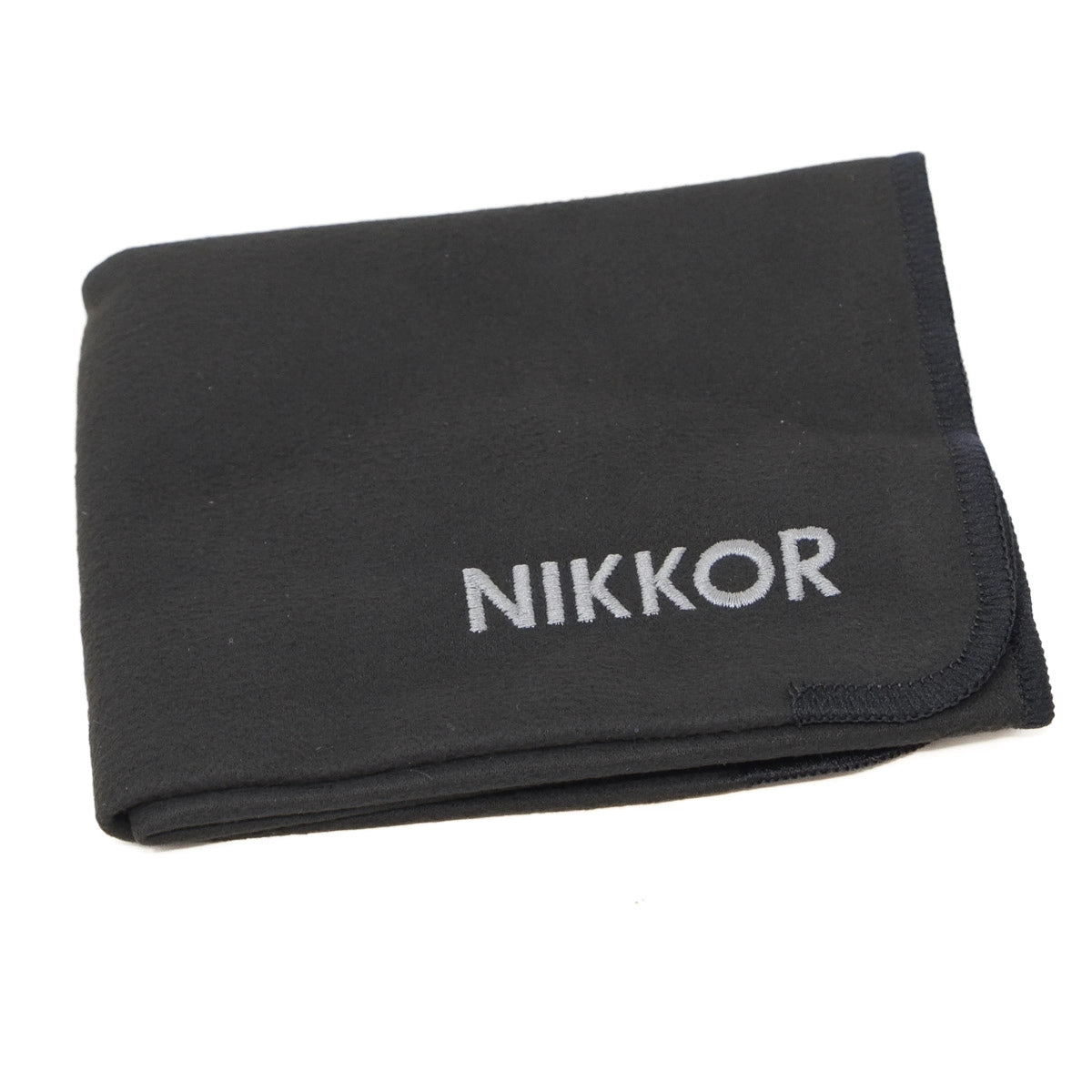 Black cloth with 'Nikkor' branding on a white background