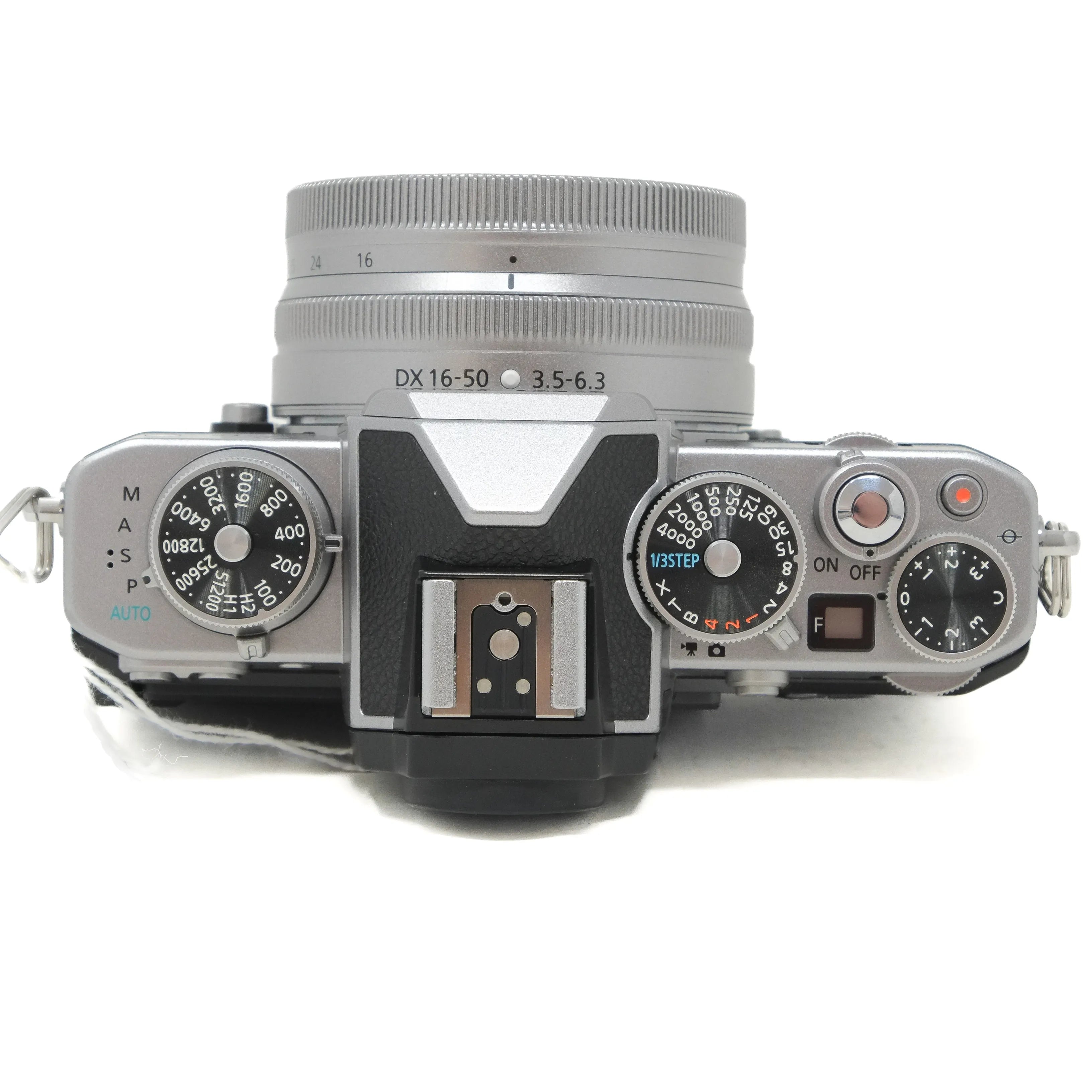 Vintage camera with lens and control dials on a white background