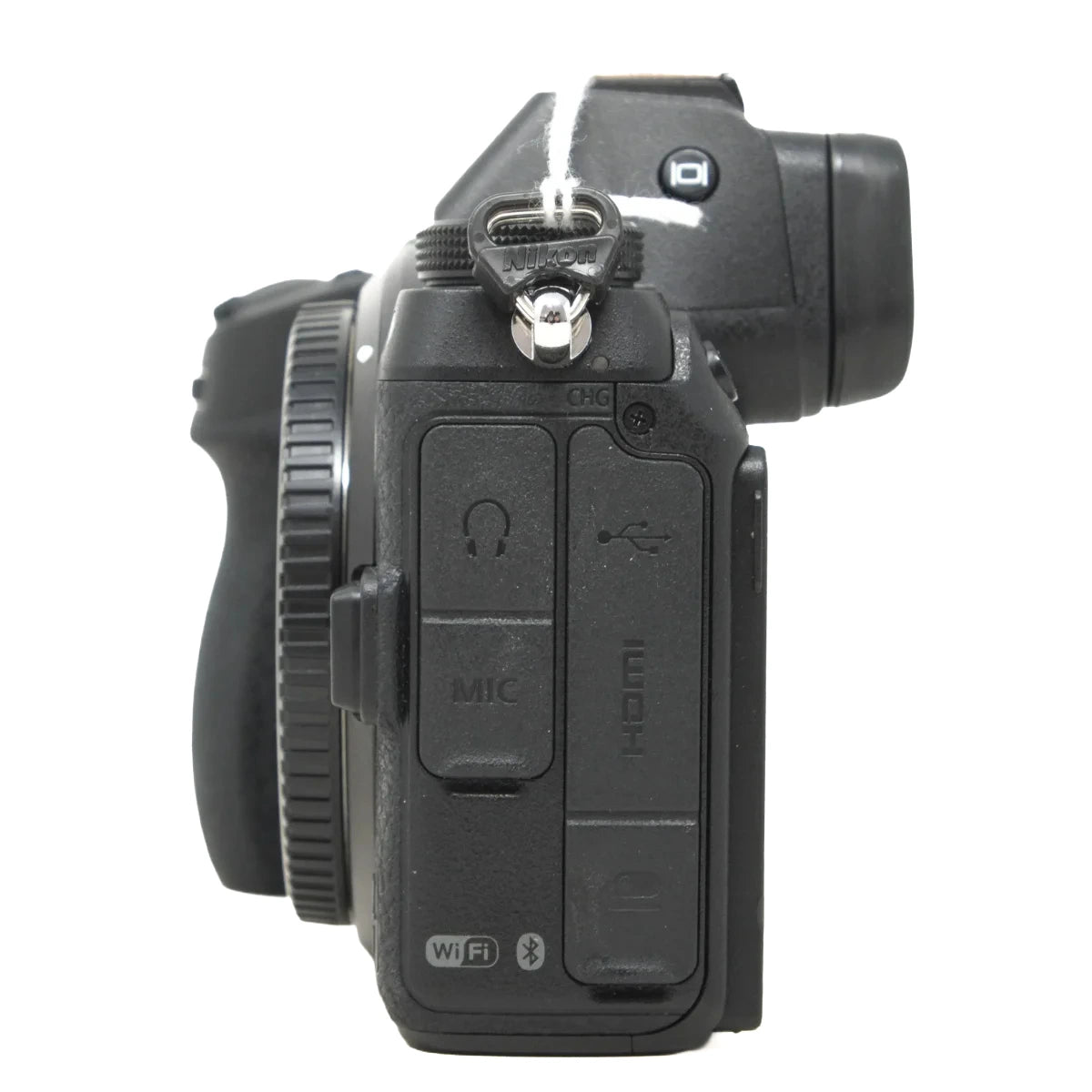 A black mirrorless camera body shown from the rear/top side, featuring a textured grip, hot shoe, and control buttons including a headphone jack, MIC, USB-C, and Wi-Fi symbol, photographed on a white background.