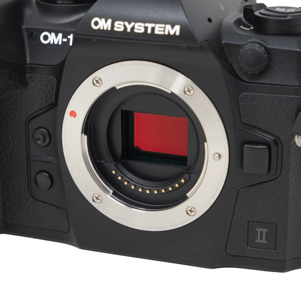 Camera body with 'OM SYSTEM' branding on a white background