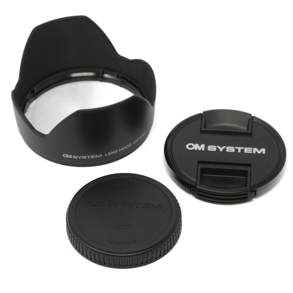 Set of black camera lens caps and lens hood with 'OM SYSTEM' branding on a white background