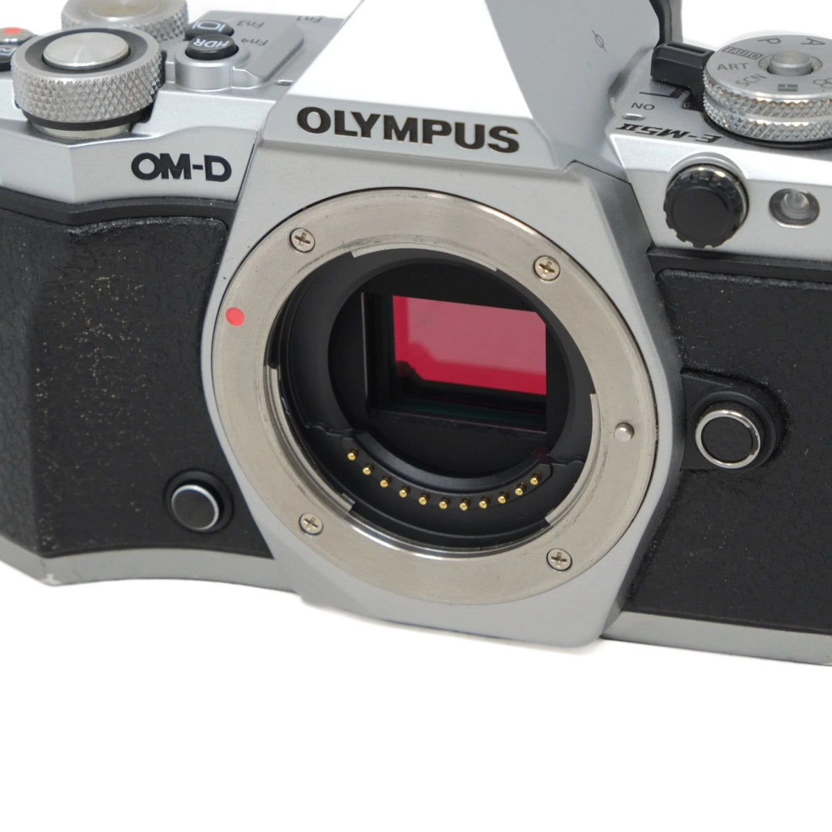 Olympus camera body without a lens on a white background