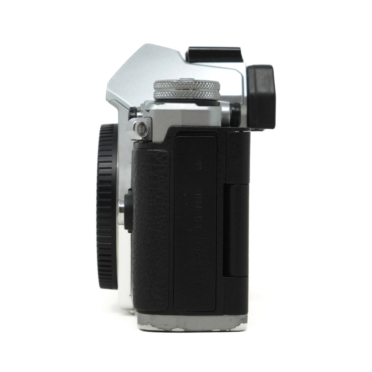 Vintage camera body with lens and control knobs on a white background