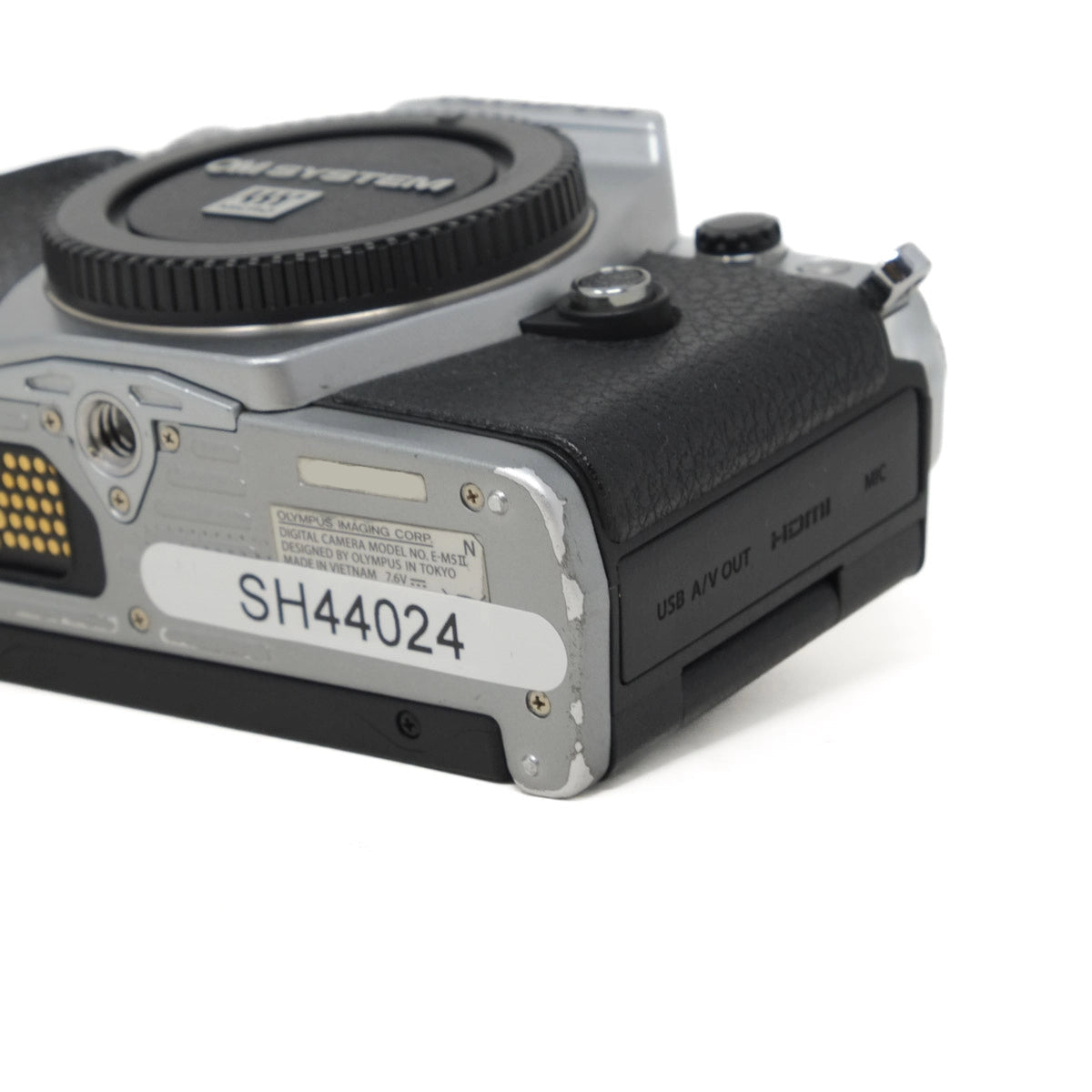 Close-up of a camera body with brand logo on a white background