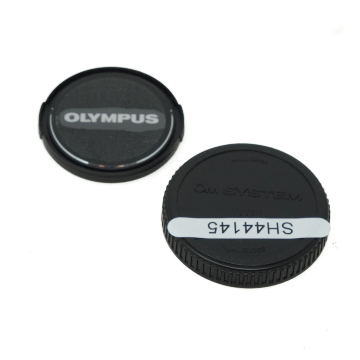 Two camera lens caps, one with 'Olympus' branding and the other with model number 'SH44145'.