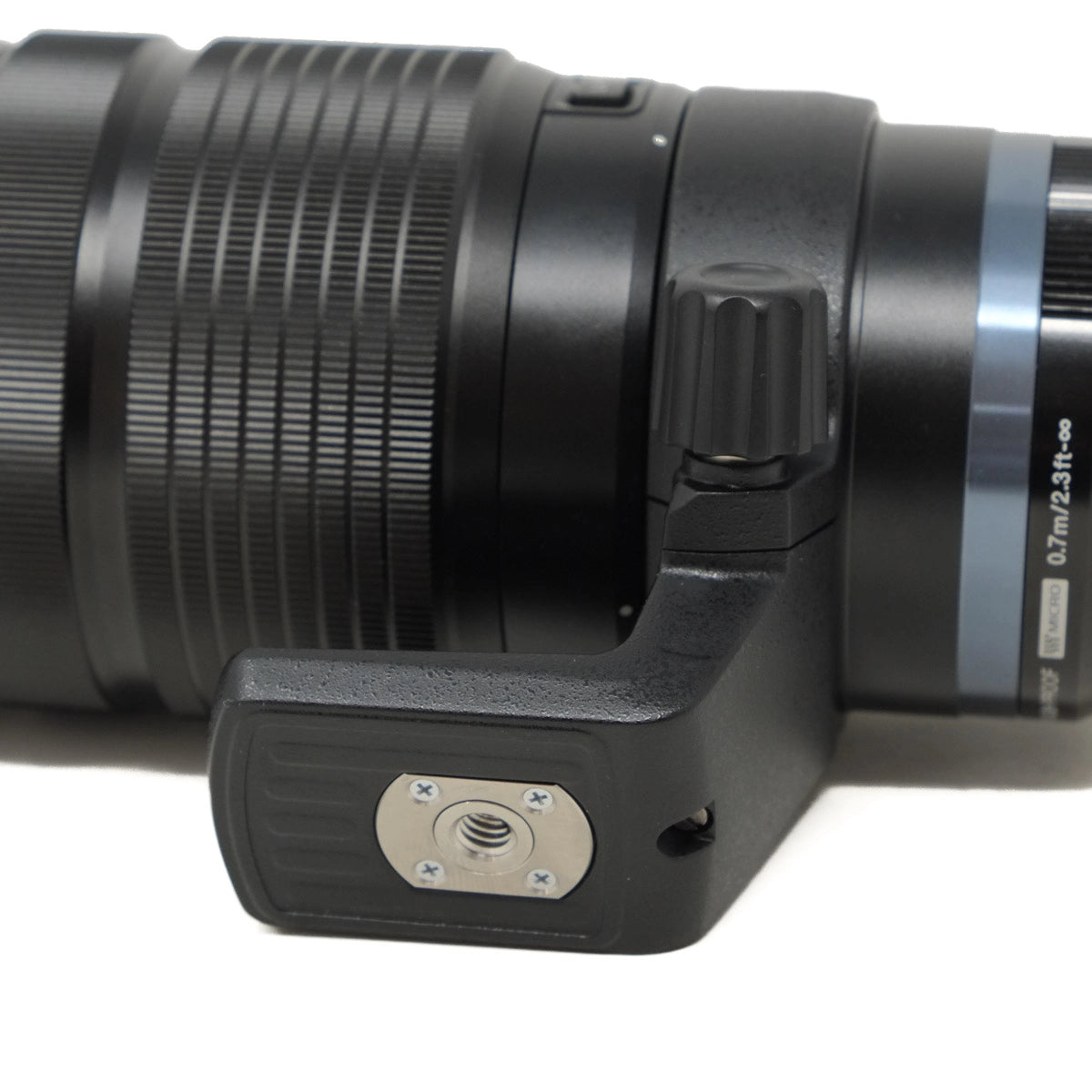 Close-up of a camera lens and its mount on a white background