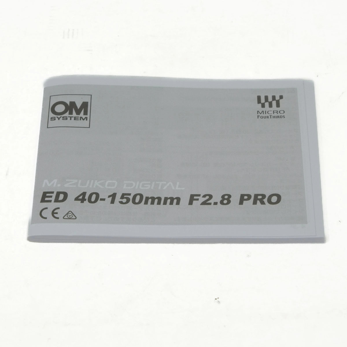 Camera lens with OM System and M.Zuiko Digital branding on a white background