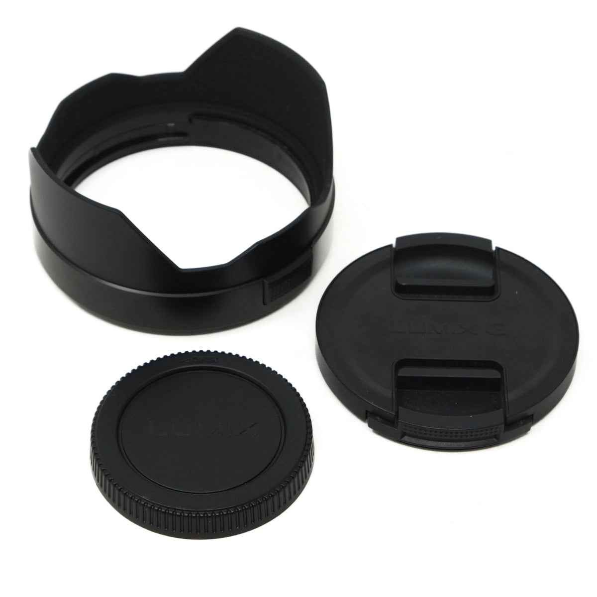 Set of black camera lens accessories on a white background