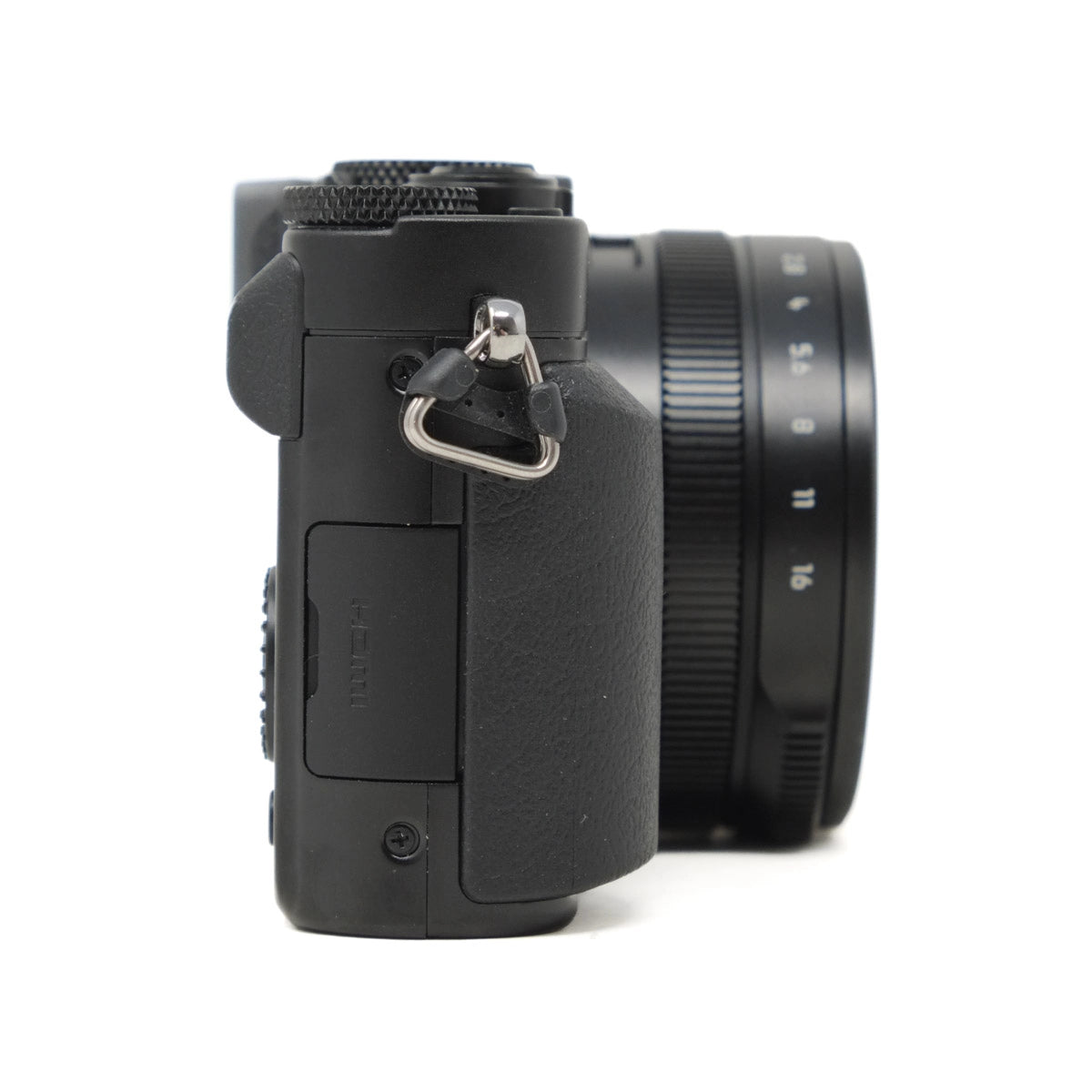 Black camera body with lens on a white background