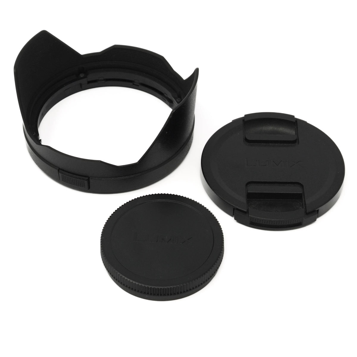 Set of black camera lens caps and lens hood on a white background