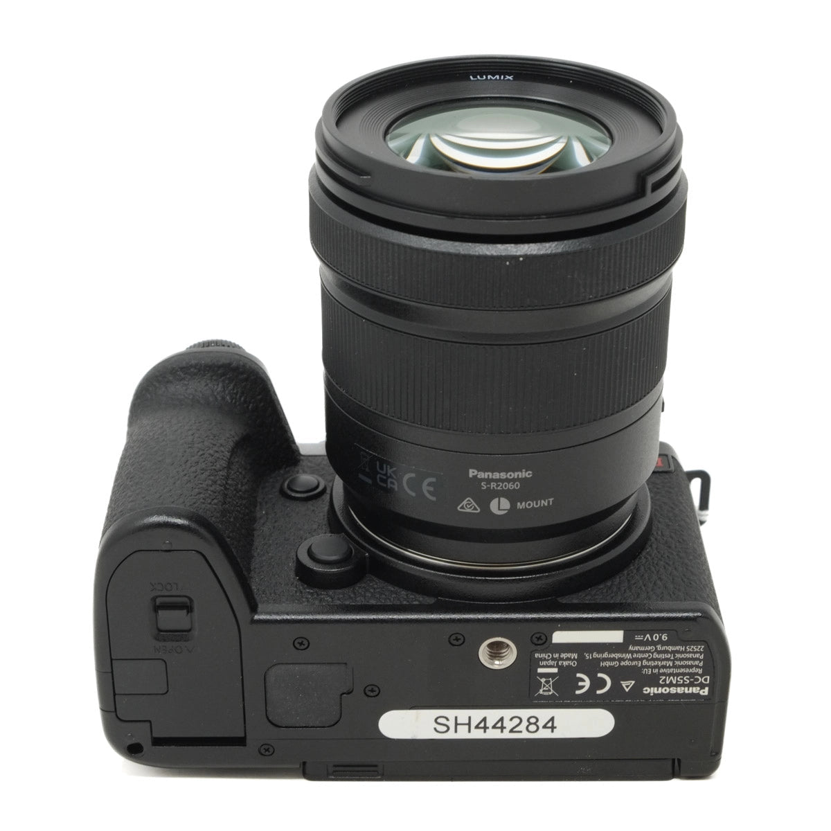 Camera body with lens on a white background