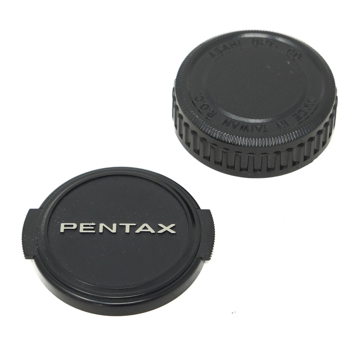 Two black Pentax camera lens caps on a white background