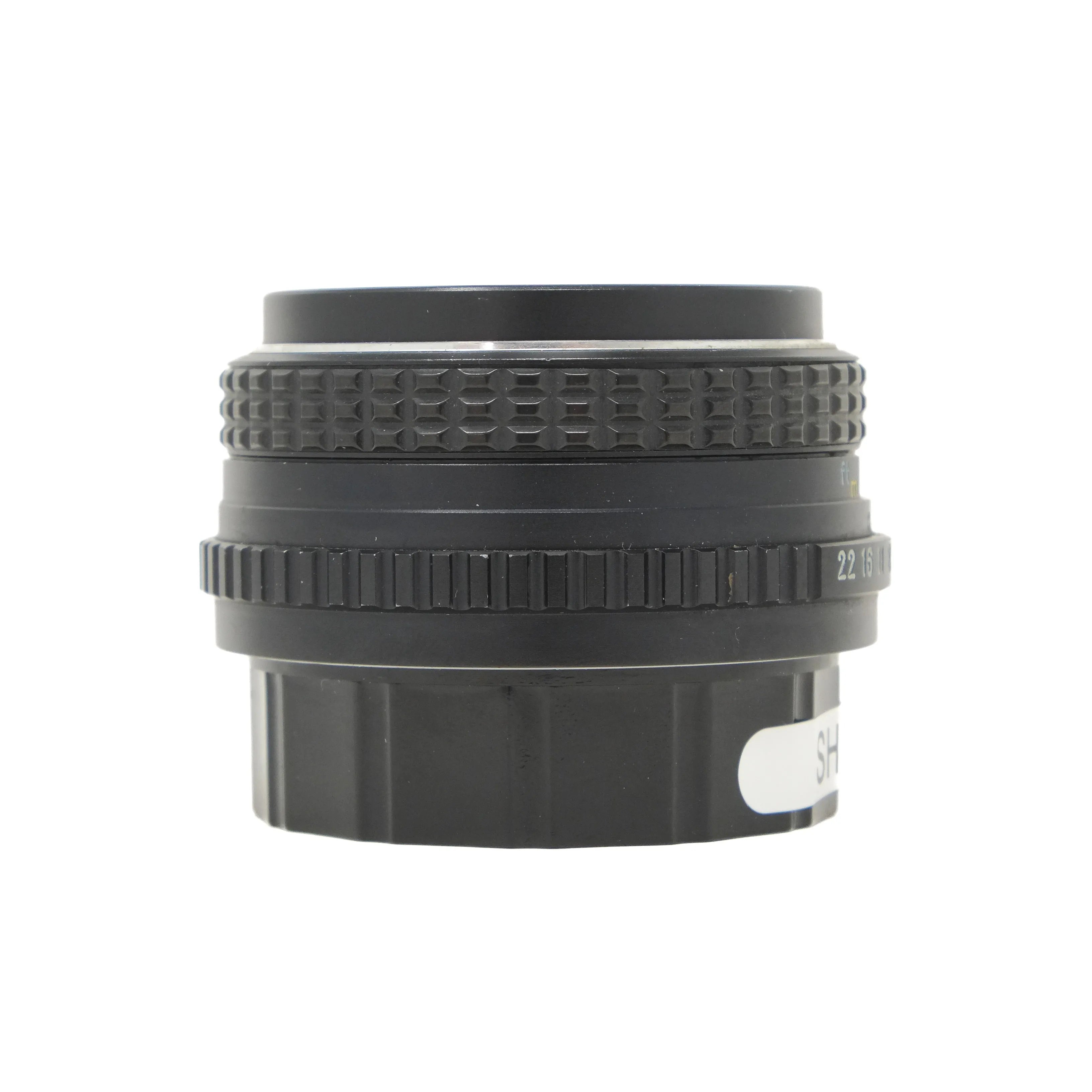 Black camera lens with focus ring on a white background