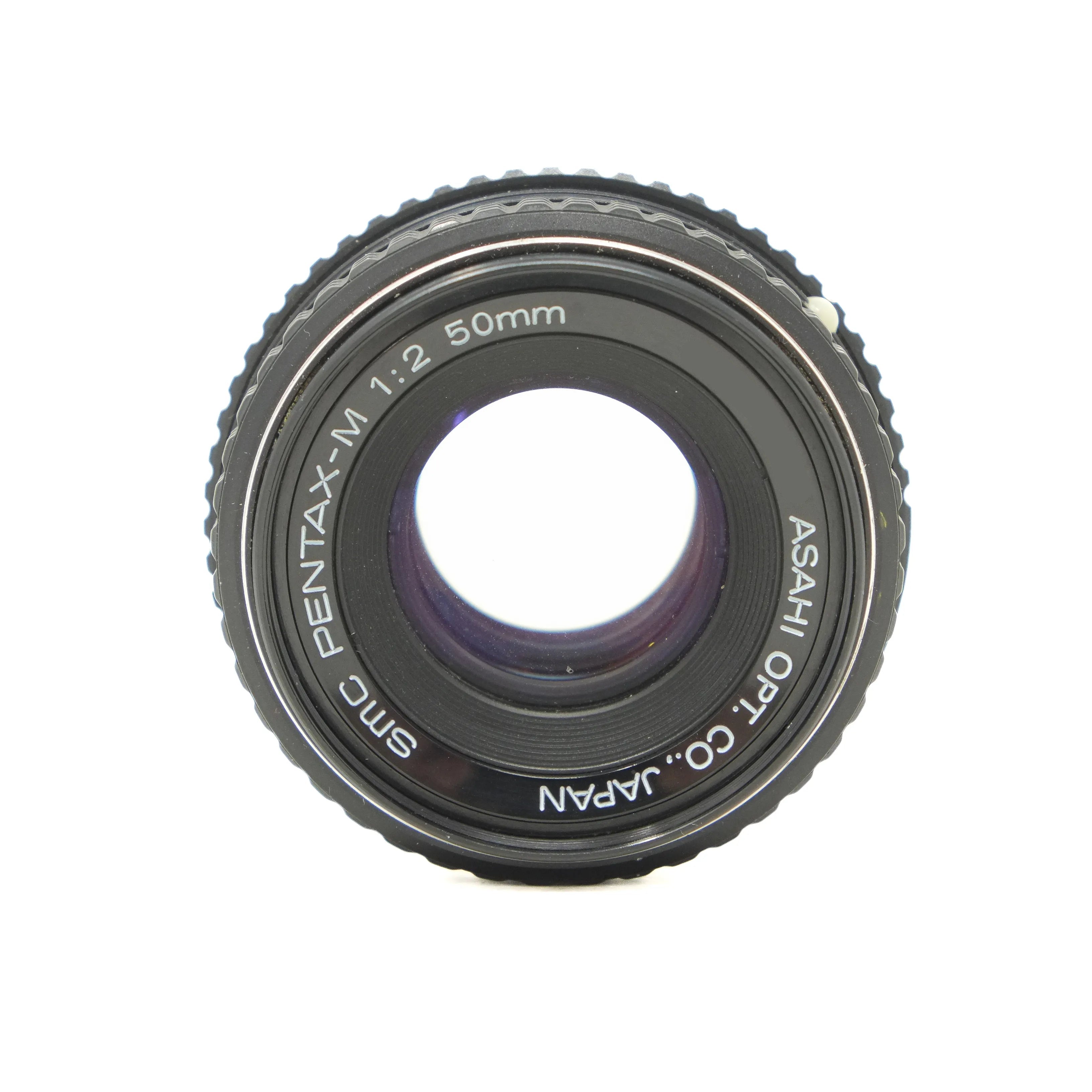 Camera lens with 'Pentax' branding on a white background