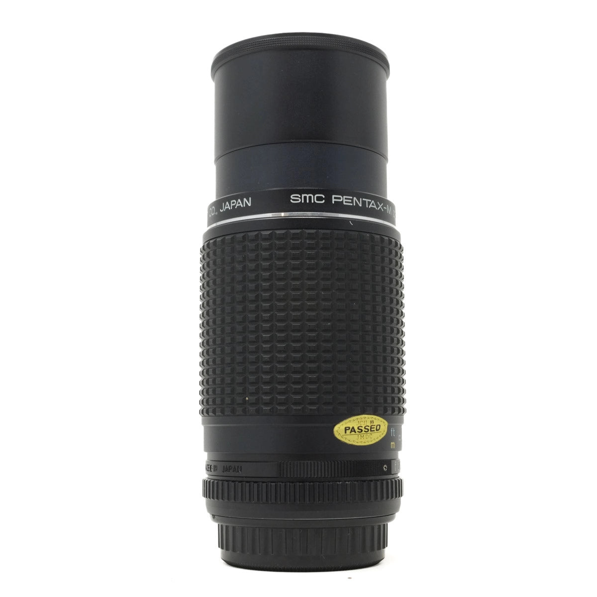 Black camera lens with 'SMC Pentax-DA' branding on a white background