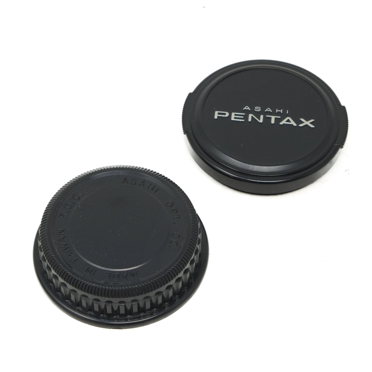 Two black camera lens caps with 'Asahi Pentax' branding on a white background.