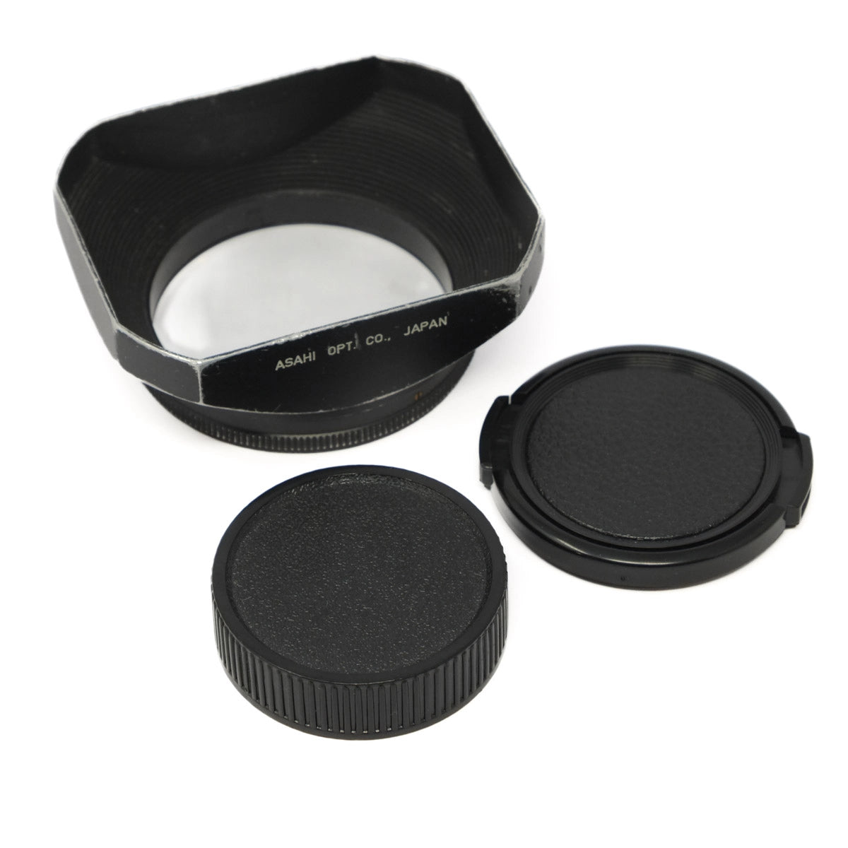 Camera lens hood and black lens caps on a white background