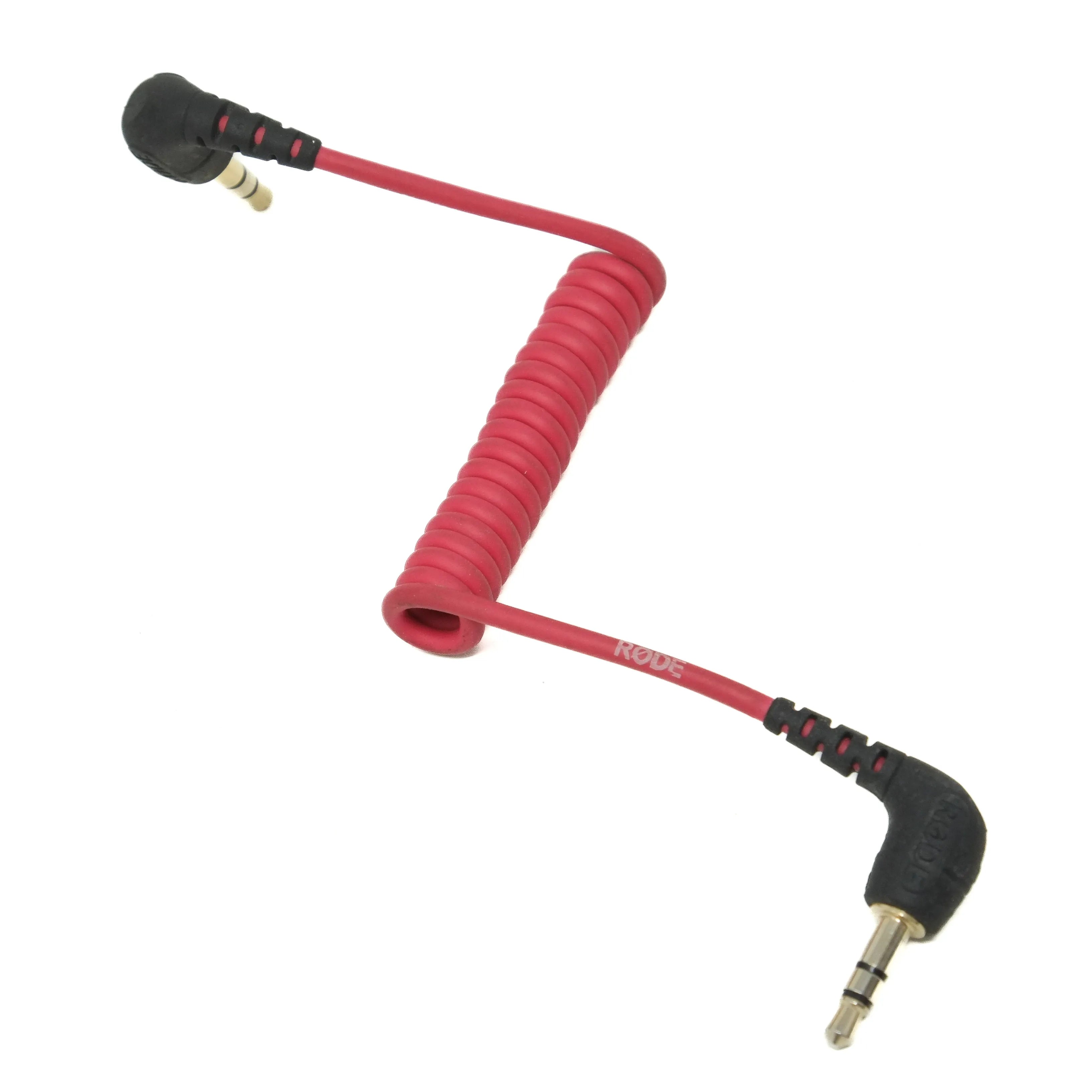 Coiled red cable with black connectors on a white background
