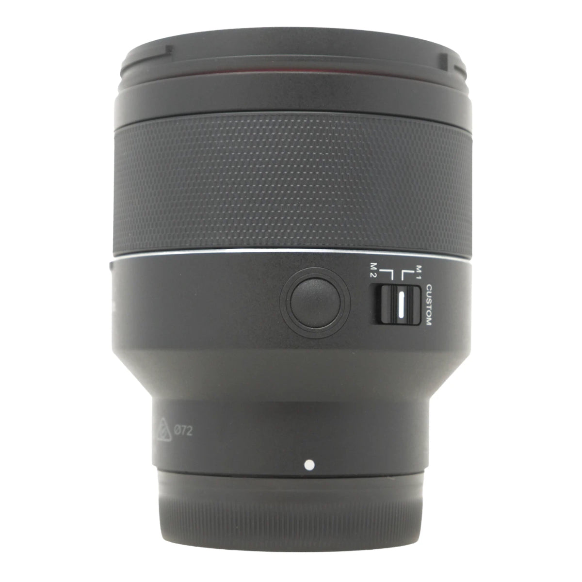 A black camera lens with a textured grip, a focus lock button, and a switch labeled M2 and CUSTOM, shown against a plain white background.