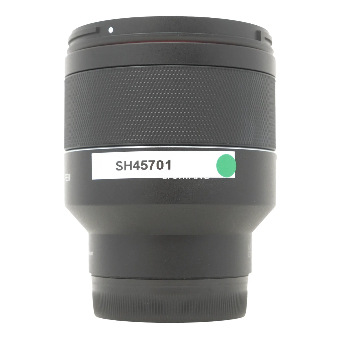 A black camera lens with a white label reading 'SH45701' and a small green circle, photographed against a plain white background.
