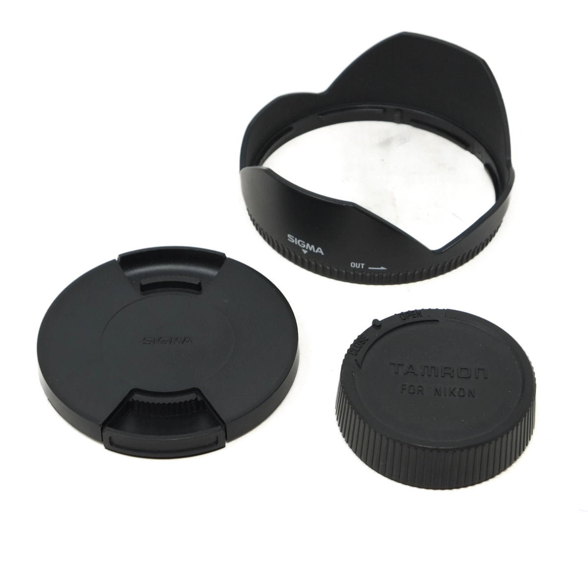 Camera lens caps and hood with Sigma and Tamron branding on a white background
