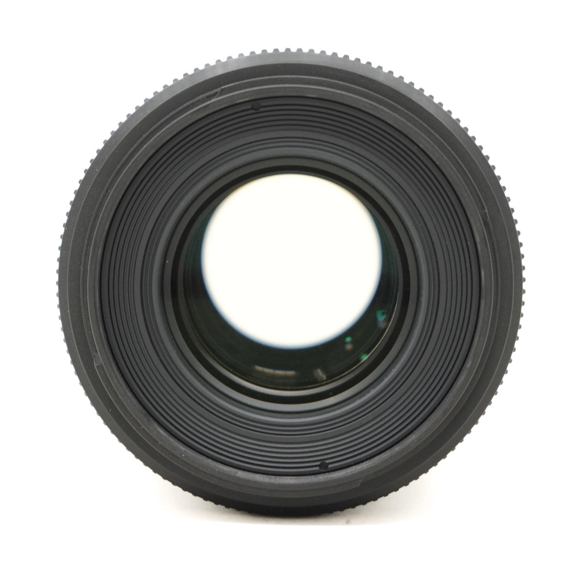 Close-up of a black camera lens on a white background