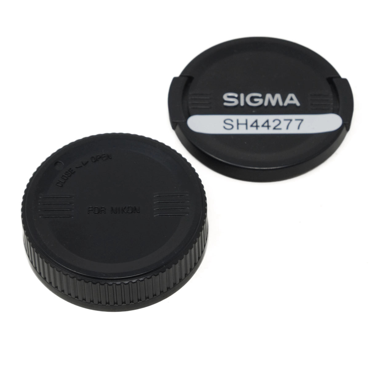 Two black camera lens caps with 'Sigma' branding on a white background