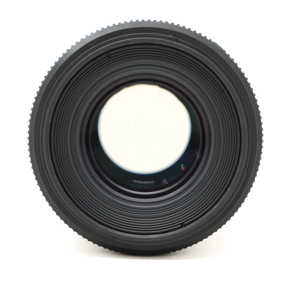 Close-up of a black camera lens on a white background