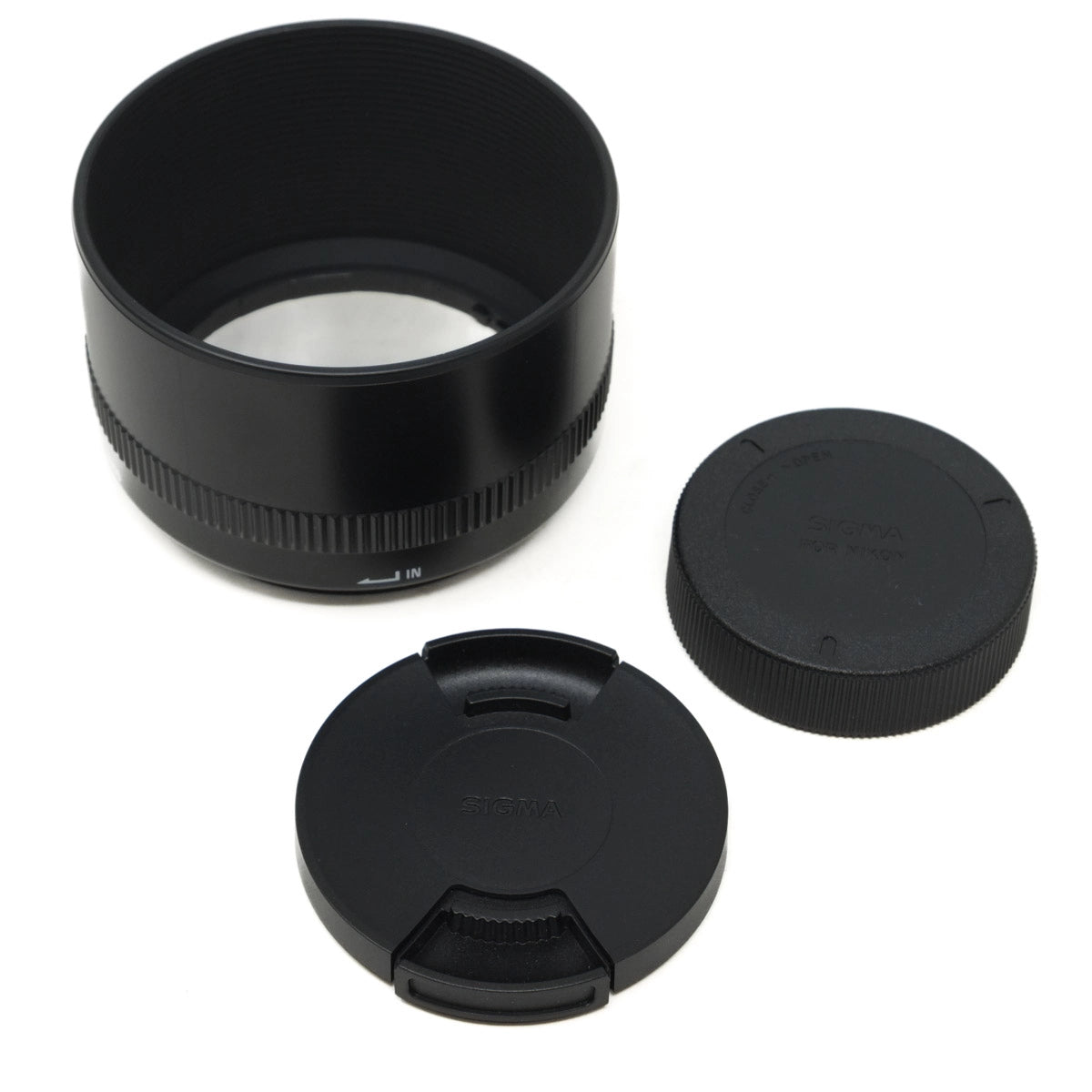 Camera lens with various lens caps on a white background