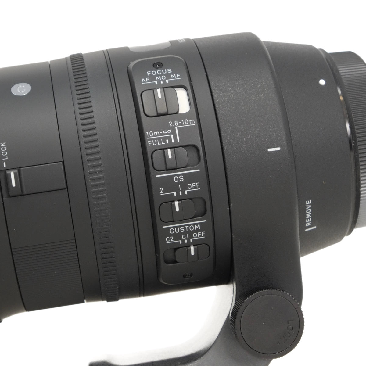 Close-up of a camera lens with control buttons on a white background