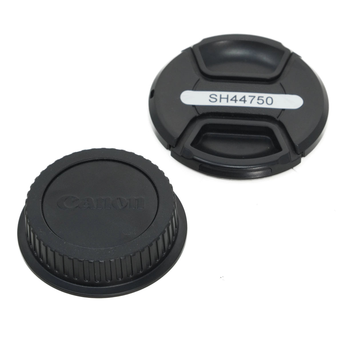 Two black camera lens caps on a white background, one with 'Canon' branding and the other with 'SH44750'.