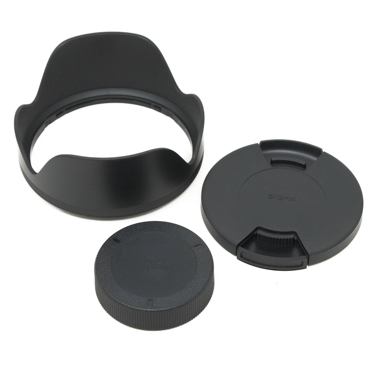 Sigma lens hood and caps on a white background