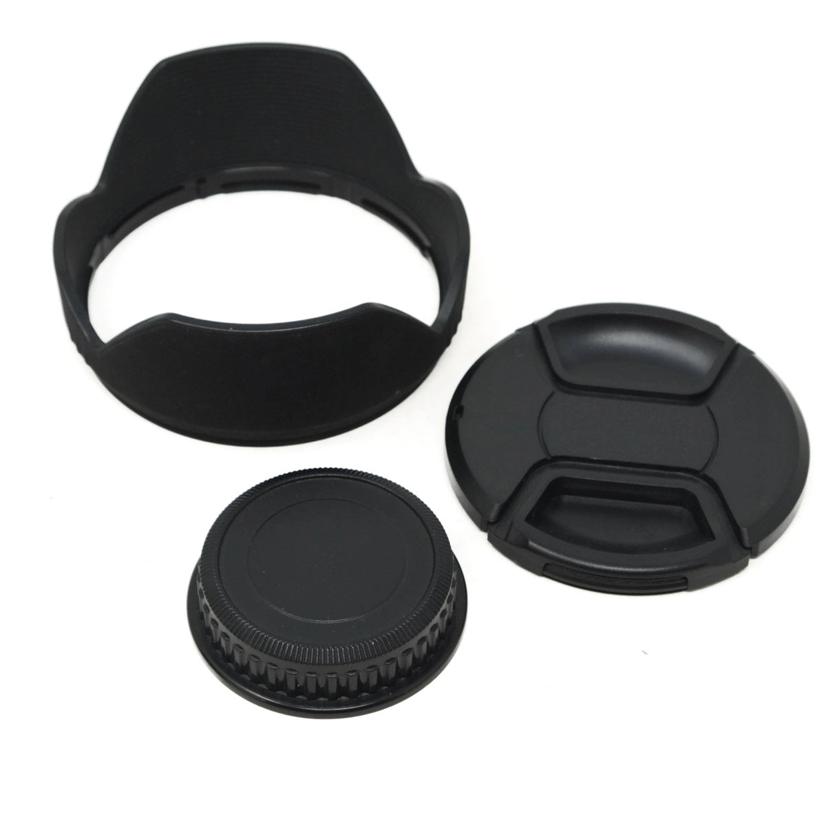 Set of black camera lens caps and hood on a white background