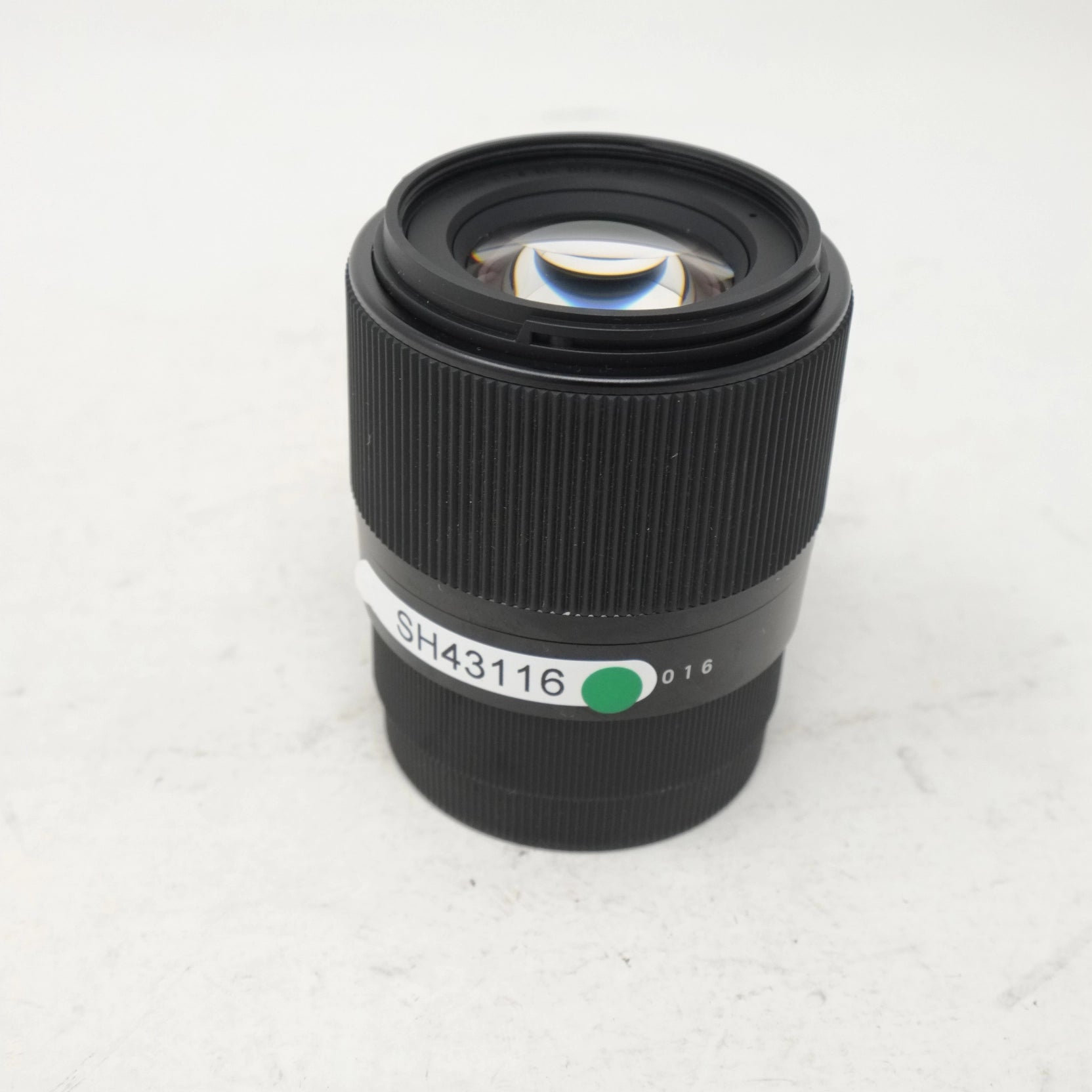 Camera lens with a visible model number on a white background