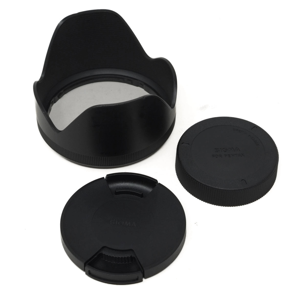 Set of black camera lens caps and lens hood on a white background
