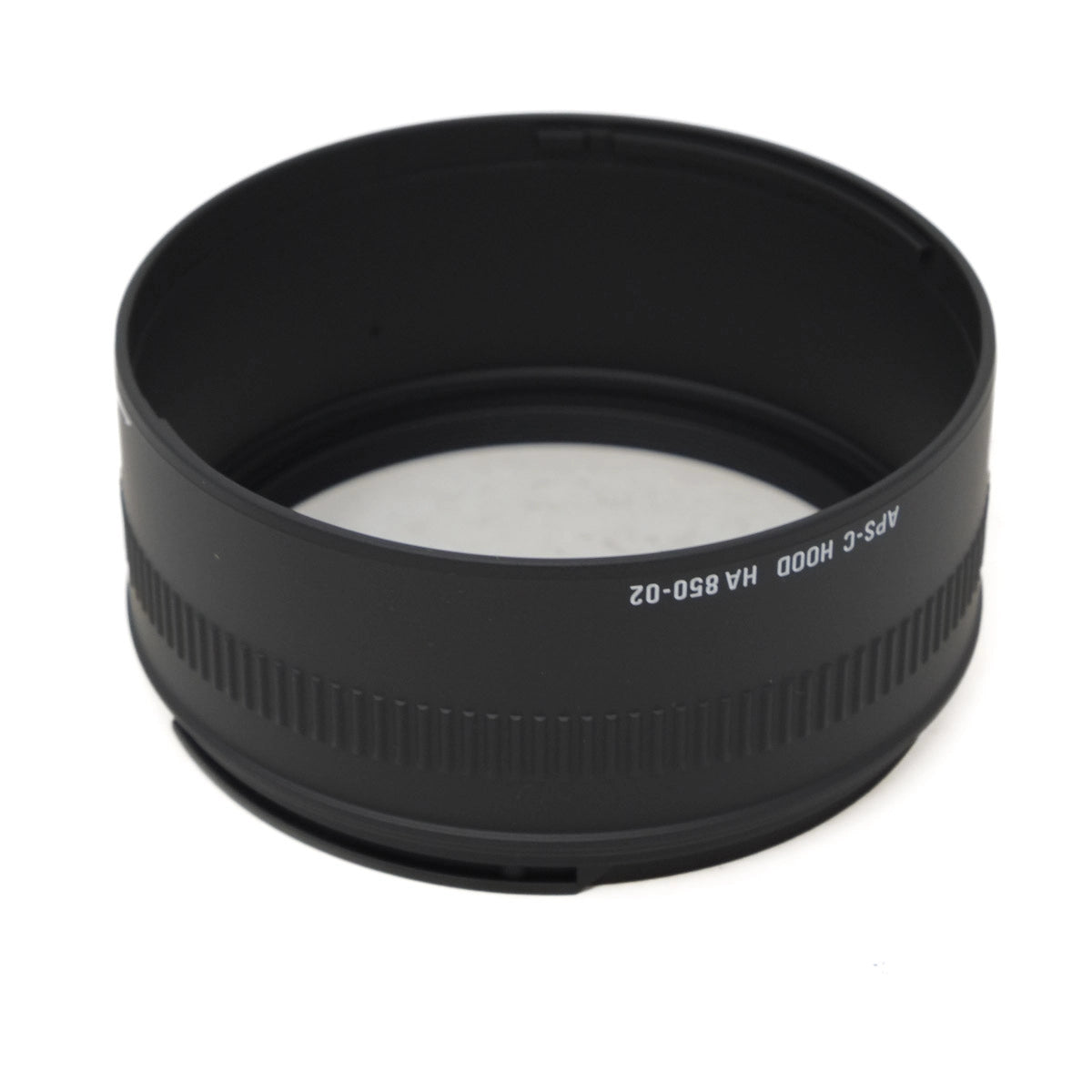 Black camera lens APS-C hood on a white background