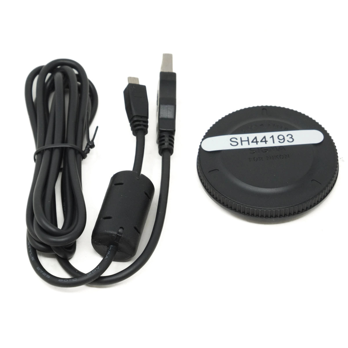 Cable and lens cap on a white background