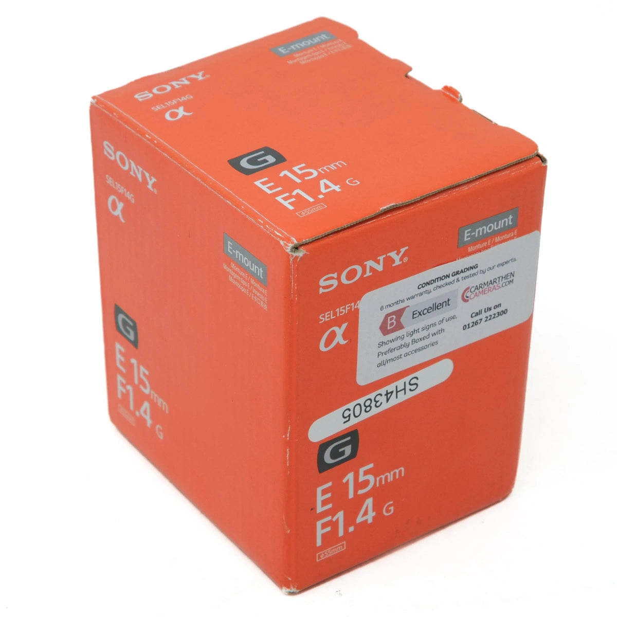 Orange Sony camera lens packaging box on a white background