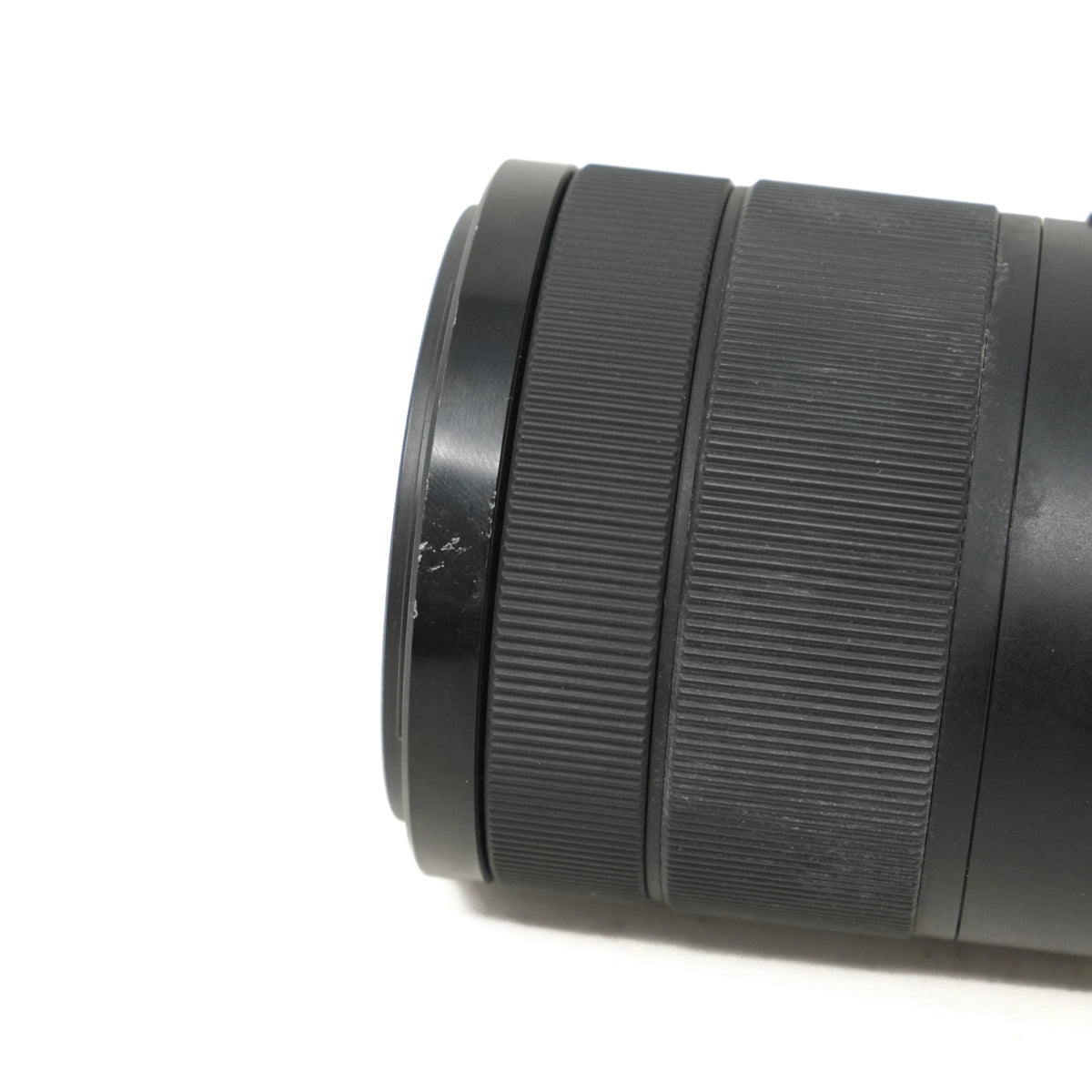 Close-up of a black camera lens on a white background