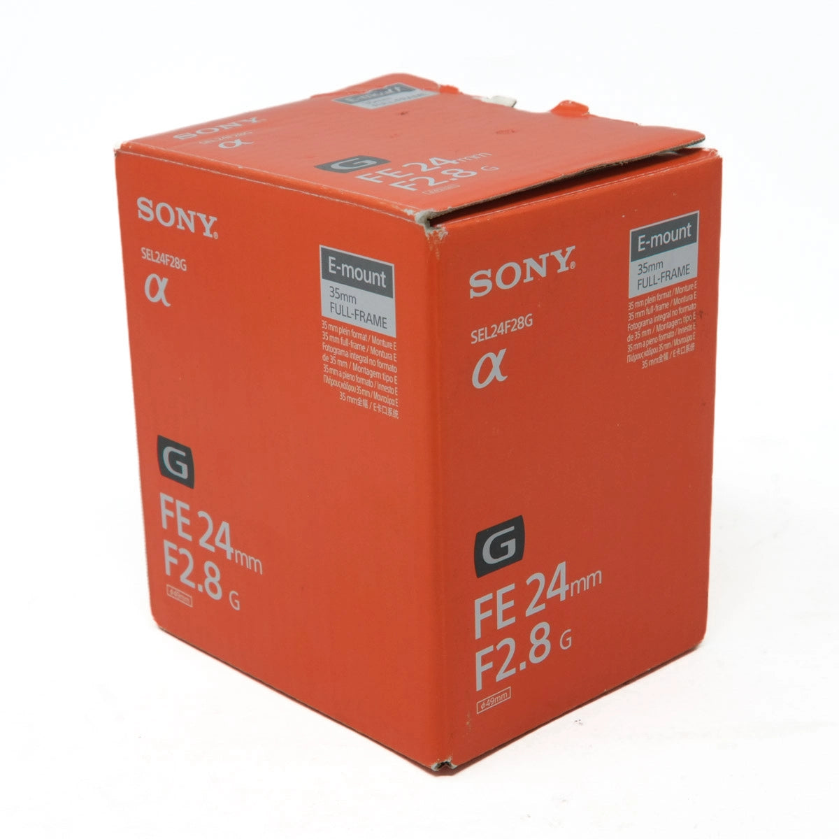 Orange Sony camera lens packaging box on a white background