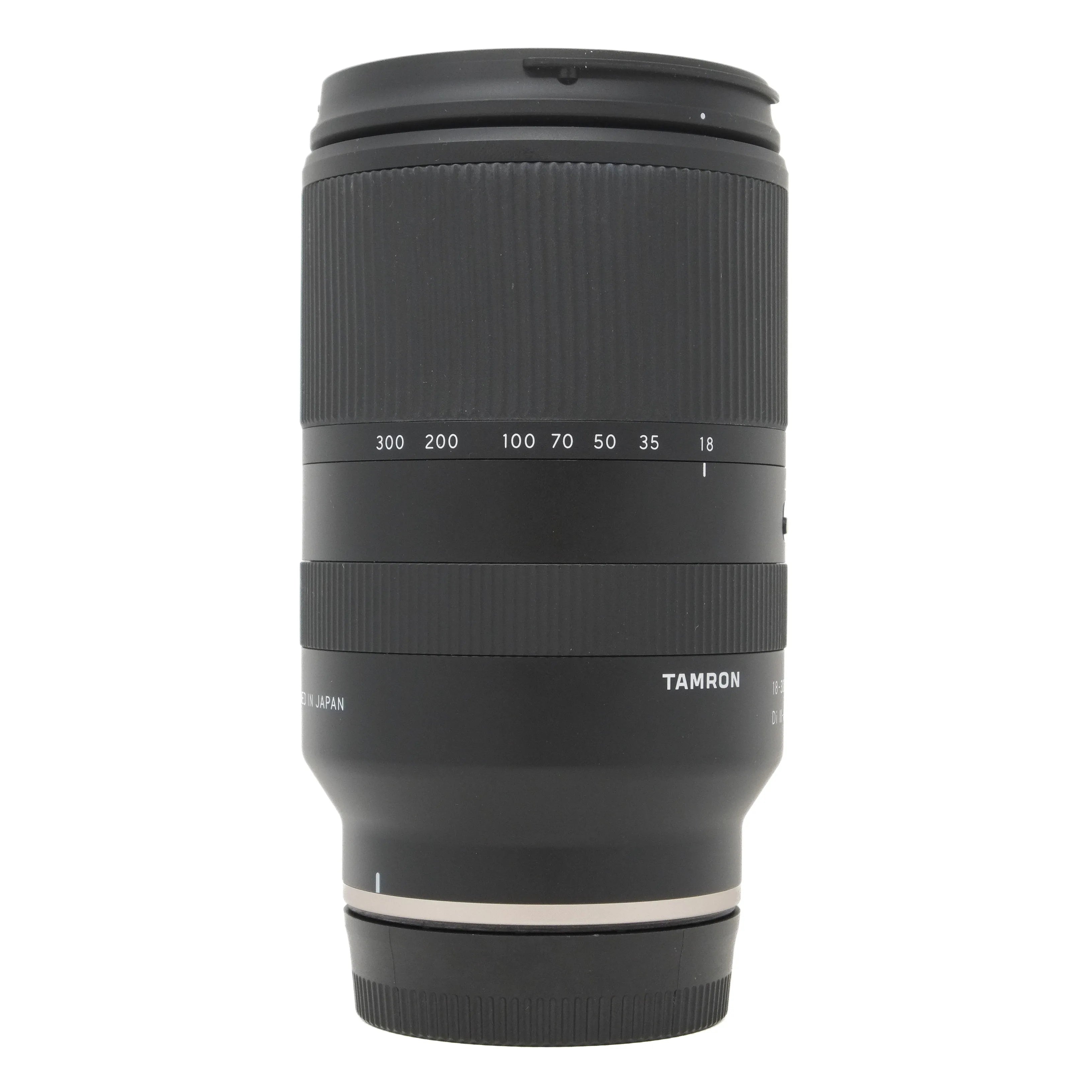Black camera lens with 'Tamron' branding on a white background