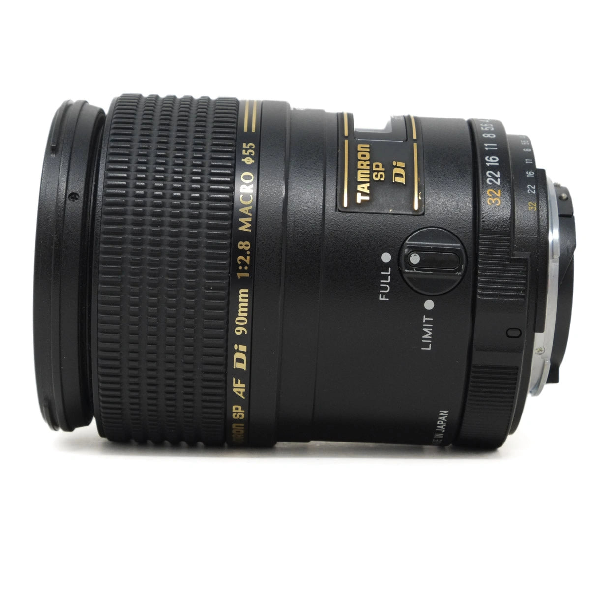 Camera lens with 'Tamron SP AF DI 90mm f/2.8 Macro' text on a white background