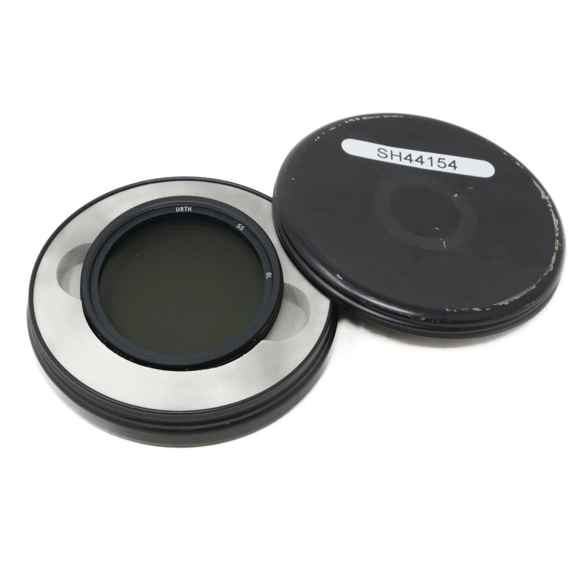 Camera lens filter with metal ring and black cover on a white background