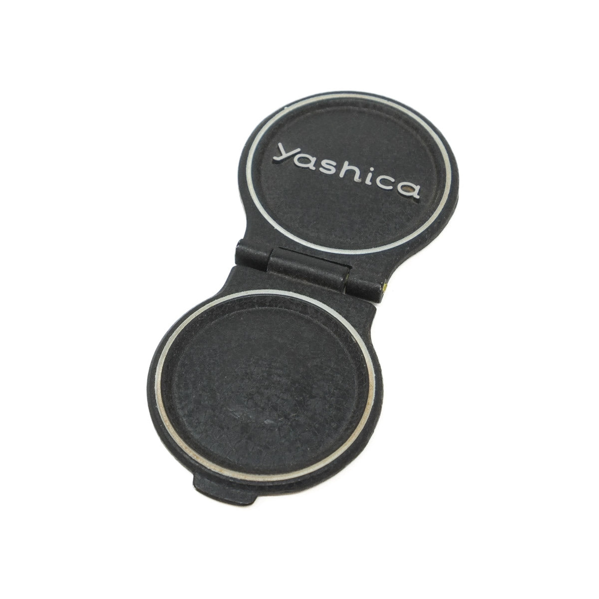 Black Yashica camera lens cap on a white background