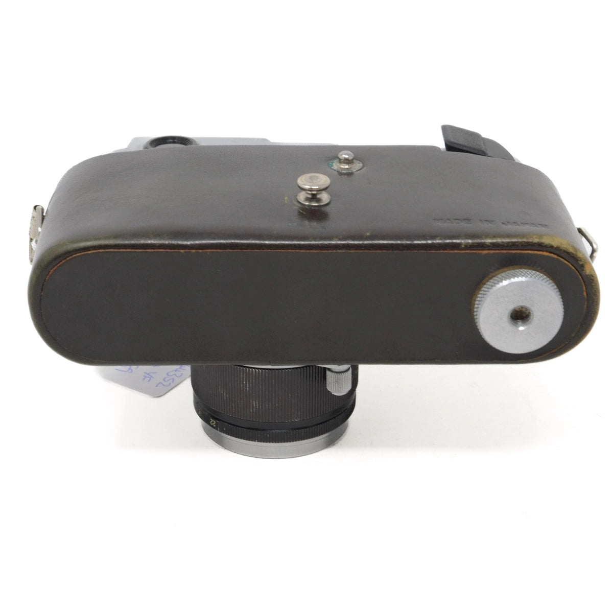 Vintage camera lens with leather case on a white background
